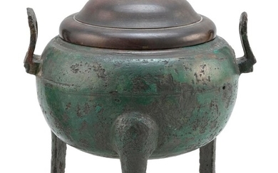 CHINESE BRONZE DING In ovoid form, with tripod base and rectangular upswept handles. Wood cover. Length 8". Ex Collection: Henry O....