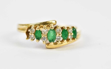 A 14ct yellow gold emerald and diamond dress ring with...