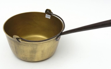 A 19TH CENTURY HEAVY BRASS JAM PAN WITH CAST IRON HANDLE AND HANGER