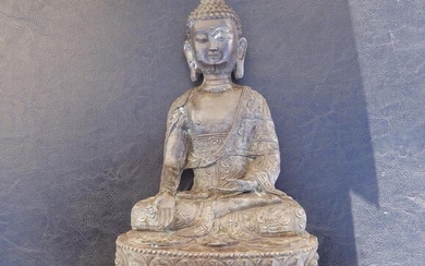 A 19thC Chinese bronze figure of Buddha, seated in...
