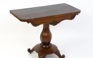 A 19thC mahogany tea table with a carved floral front panel ...
