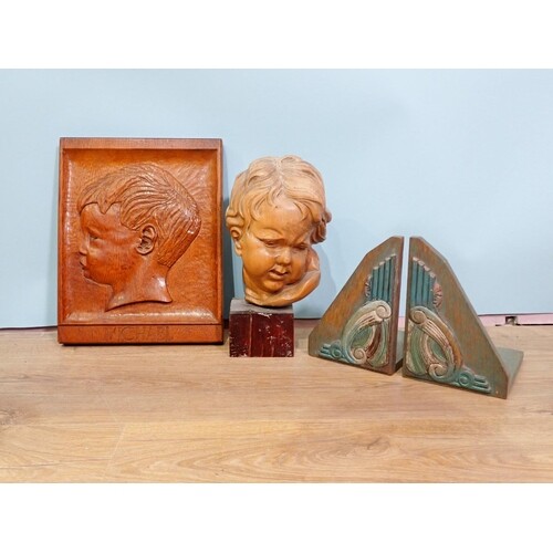 A 20th Century carved oak Panel of a boy, a pair of Art Deco...