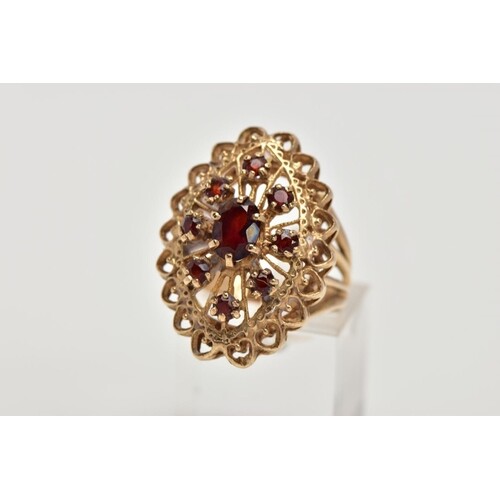 A 9CT GOLD GARNET DRESS RING, of a large openwork marquise s...