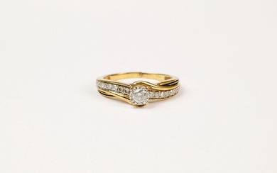 A 9ct yellow gold and diamond ring the centre brilliant cut diamond in a white gold illusion setting