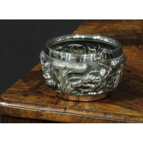 A Burmese silver circular bowl, repousse chased with hunting...