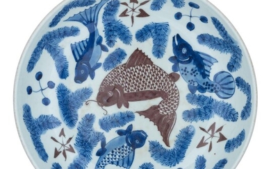 A Chinese blue and white and copper-red 'Carps' plate, ø 29 cm