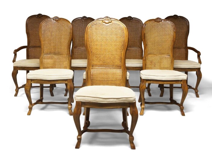 A Dutch style hardwood dining room suite, comprising eight cane-work chairs with padded seats, consisting of six side chairs and two carver chairs, 105cm high; together with a twin pedestal dining table, 75cm high, 180cm long, 115cm wide; and a...