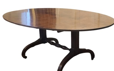 A GEORGIAN SOLID MAHOGANY DINING TABLE The oval tilt top wit...
