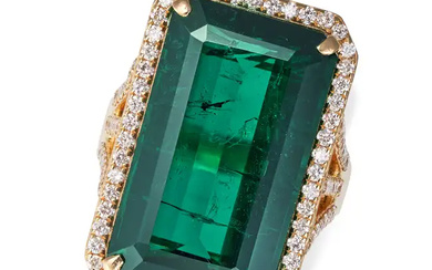 A GREEN TOURMALINE AND DIAMOND RING set with an oc ...