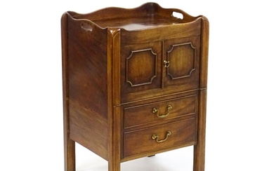 A George III mahogany tray top commode / bedside cabinet wit...