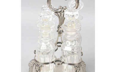 A George IV silver cruet stand, with four glass bottles.