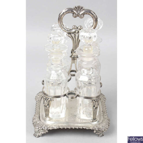 A George IV silver cruet stand, with four glass bottles.