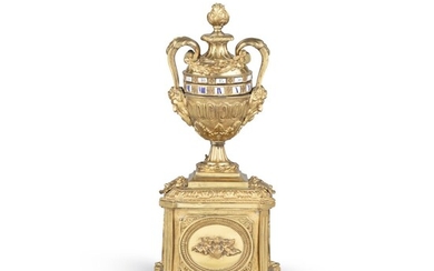 A Louis XVI style gilt-bronze cercles tournants urn clock | Pendule urne à cercles tournants en bronze doré de style Louis XVI