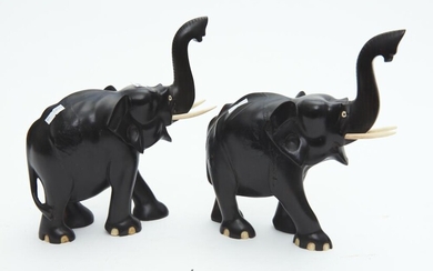 A PAIR OF CEYLONESE EBONY AND BONE CARVED ELEPHANTS WITH RAISED TRUNKS