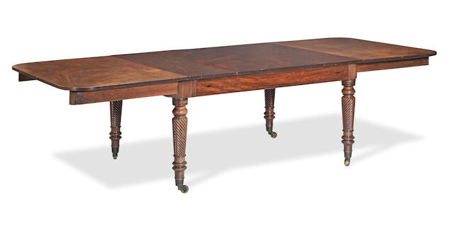 A Regency mahogany and ebonised inlaid extending dining table
