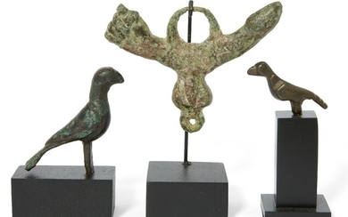 A Roman bronze phallic amulet, 1st-2nd Century A.D., and two Byzantine bronze birds, with central male genitalia, with manus finca and phallus, a large suspension loop above, a small loop below, 7.5cm wide; and two Byzantine bronze birds with...