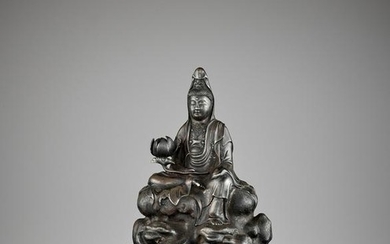 A SILVERED 'ROYAL EASE' BRONZE GUANYIN EARLY QING
