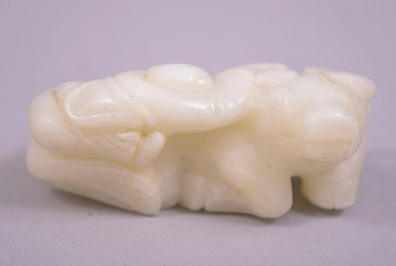 A SMALL CHINESE JADE CARVING OF A BUFFALO, with a