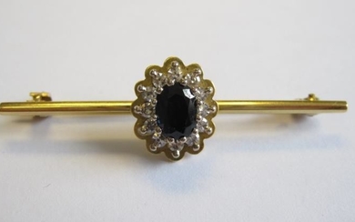 A Sapphire and Diamond Bar Brooch claw-set oval-cut sapphire...