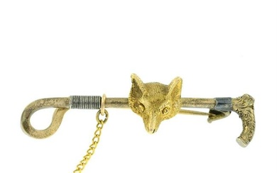 A Victorian 15ct gold fox mask and riding crop bar brooch.