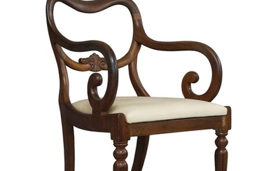 A William IV mahogany open arm elbow chair, with carved floral back rail, above drop in seat, raised on turned reeded front legs Provenance: Peter Jones, London, January 1995. The Geoffrey and Fay Elliot collection.