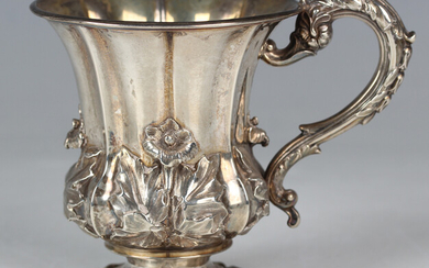 A William IV silver christening mug of lobed tapering form, decorated in relief with a band of flowe