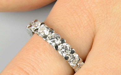 A brilliant-cut diamond tapered full eternity ring.