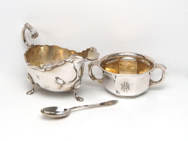 A cased silver porringer and spoon, the porringer Birmingham, c.1930, William Greenwood & Sons, the spoon by the Adie Brothers, Birmingham, c.1930, both engraved with monogram, together with a silver gravy boat, Birmingham, c.1927, William...