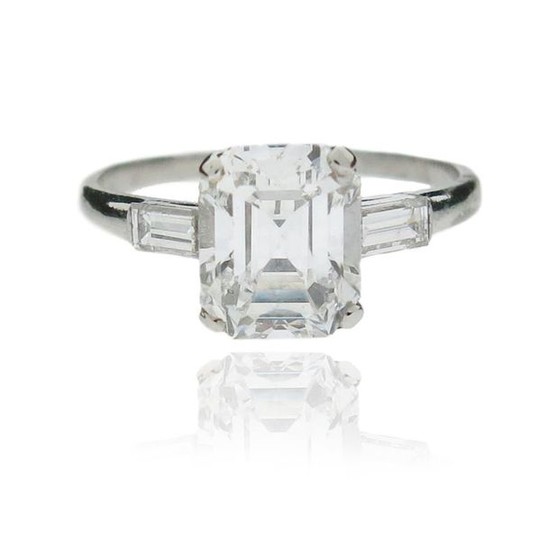 A diamond solitaire ring, set with an emerald-cut...