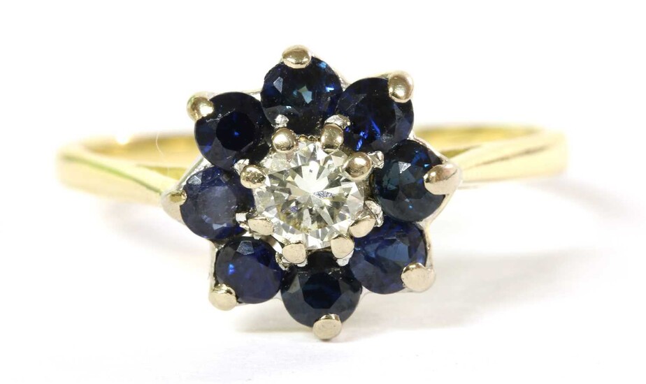 A gold diamond and sapphire cluster ring
