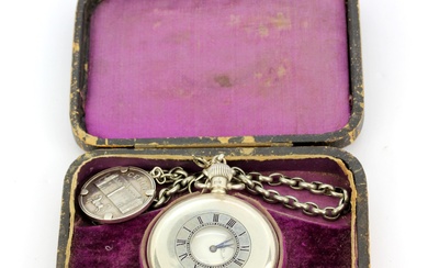 A hallmarked silver cased top wind pocketwatch on a hallmarked silver Albert chain in a presentation case.