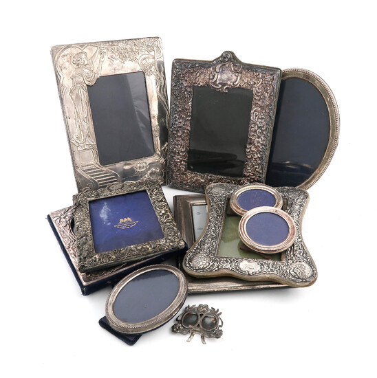 A large collection of silver photograph frames