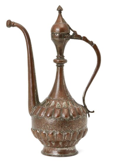 A large tinned copper ewer, probably Bukhara, Central Asia, 18th century, on a short spreading foot, the globular body with fluted elements above and below a band of engraved flower heads and vines, the slender neck with central ring and crenelated...