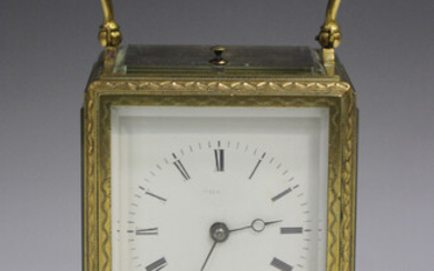 A late 19th century French engraved brass one-piece cased carriage alarm clock with eight day moveme