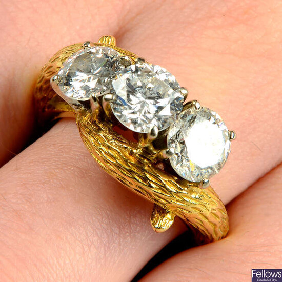 A mid 20th century 18ct gold brilliant-cut diamond and laser-drilled diamond three-stone ring.