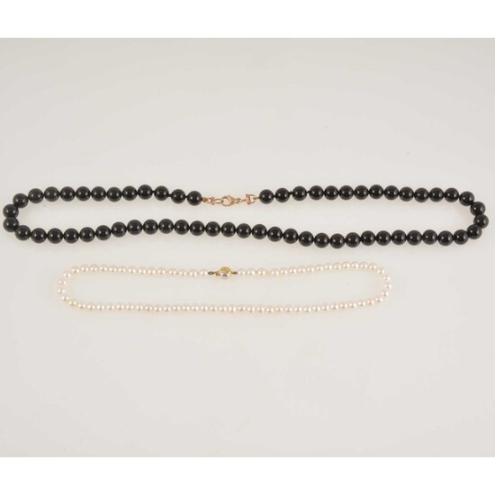 A non-graduated cultured pearl necklace and a black bead necklace.