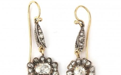 A pair of 14 karat gold and silver rose cut diamond cluster earrings. Designed as a rose with a central rose cut diamond of ca. 4.75 mm. diameter, surrounded by smaller rose cut diamonds. Gross weight: 4.8 g.