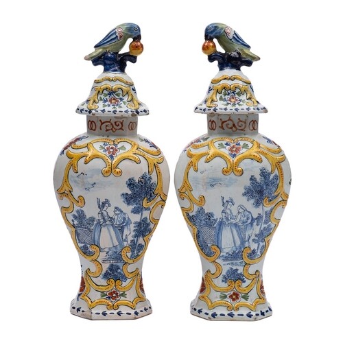 A pair of Dutch polychrome delftware vases and covers: with ...