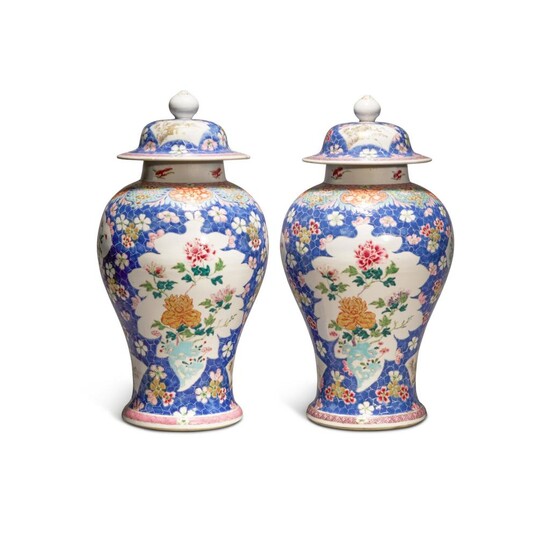 A pair of blue-ground famille-rose 'floral' baluster jars and covers, Qing dynasty, Qianlong period | 清乾隆 藍地粉彩開光花卉紋蓋罐一對