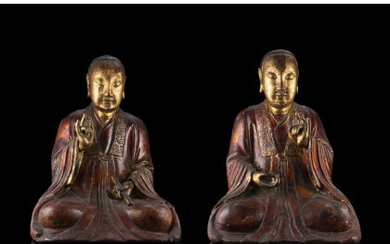 A pair of carved lacquered and part gilt figures of monks (defects) China, 19th century (h. 40.5 cm.)