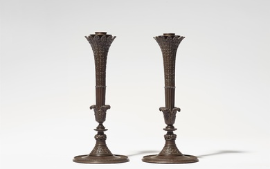 A pair of cast iron candelabra after a design by Karl Friedrich Schinkel