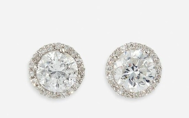 A pair of diamond and eighteen karat white gold stud