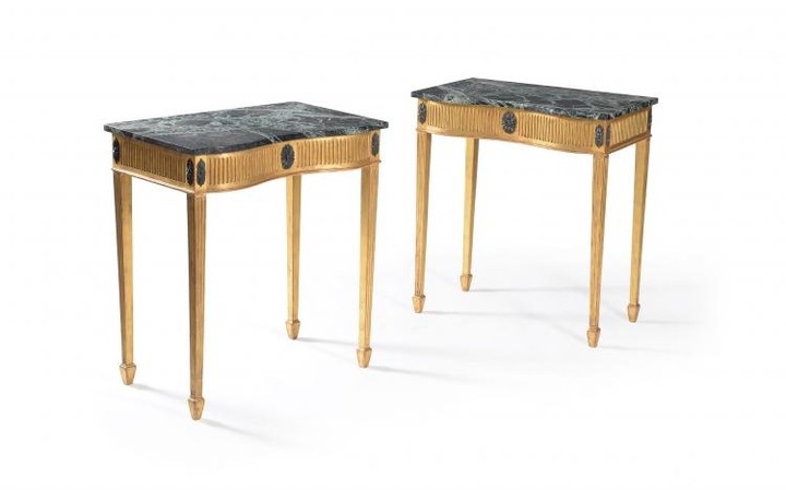 A pair of marble topped giltwood side tables