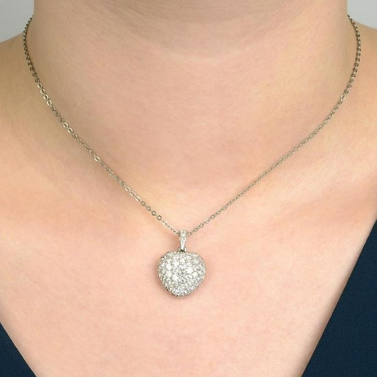 A pave-set diamond heart pendant, with chain. Estimated