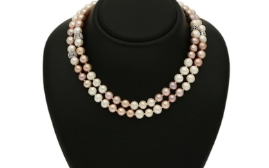A pearl necklace set with numerous cultured freshwater pearls, four beads set with numerous brilliant-cut black diamonds, mounted in 18k white gold. L. 90 cm