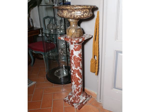 A red marble sculpture holding column