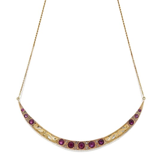 A ruby and diamond pendant necklace, designed as a crescent-shaped panel set with graduated circular-cut rubies and rose-cut diamond points, also with pierced decoration, to a fine neckchain, clasp stamped 750, pendant unmarked, approx. width of...