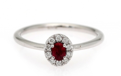 NOT SOLD. A ruby and diamond ring set with a ruby encircled by numerous diamonds,...