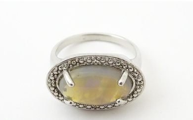 A silver ring set with opal cabochon. Ring size approx. P