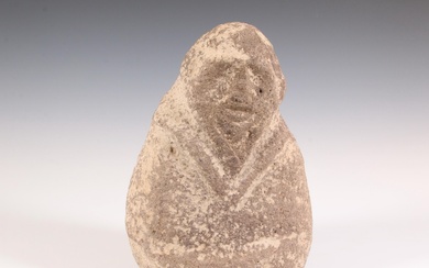 A stone anthropomorphic figure, possibly antique.